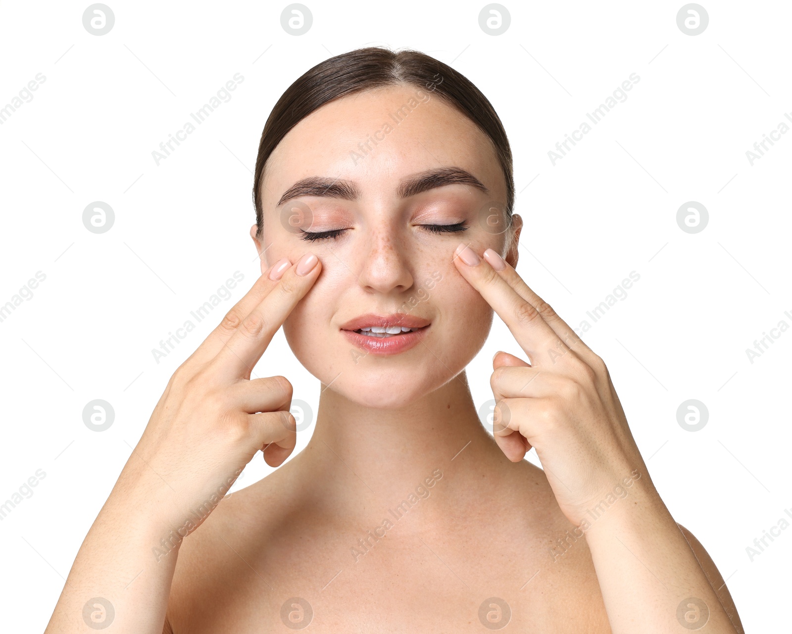 Photo of Beautiful young woman doing facial massage on white background