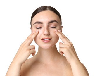 Photo of Beautiful young woman doing facial massage on white background