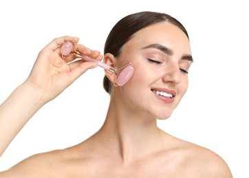 Photo of Beautiful young woman doing facial massage with roller on white background