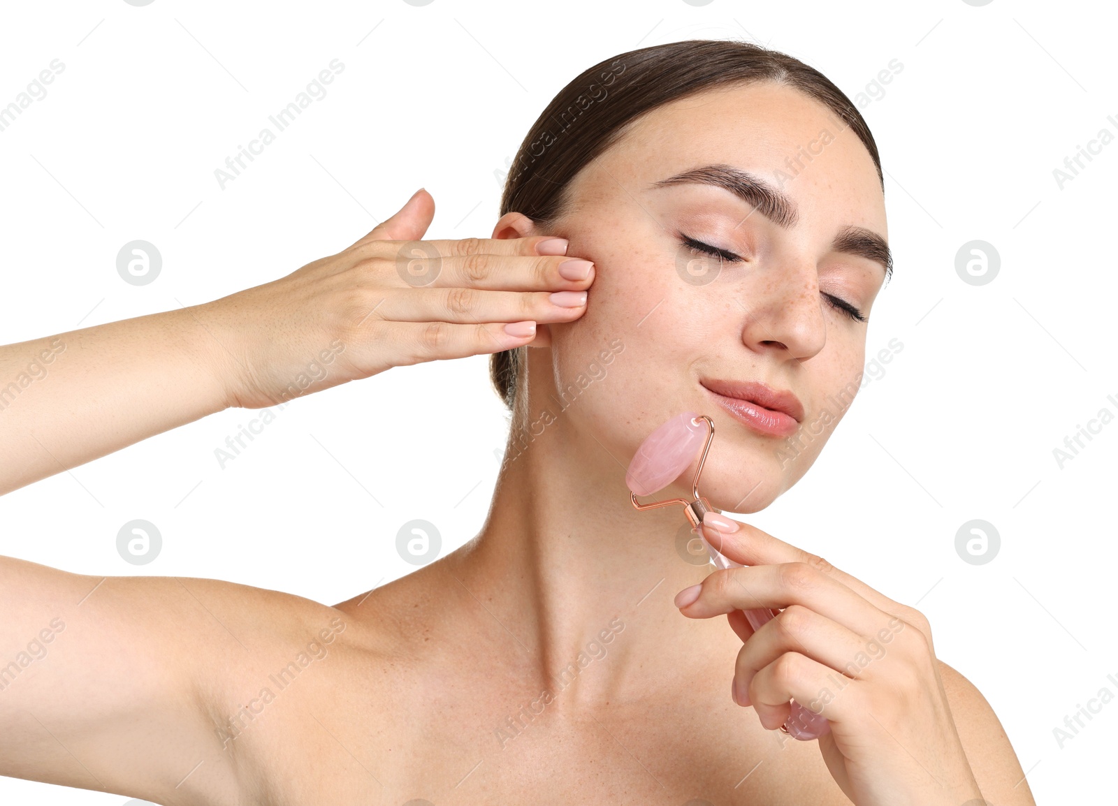 Photo of Beautiful young woman doing facial massage with roller on white background