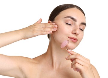 Photo of Beautiful young woman doing facial massage with roller on white background