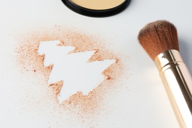 Photo of Christmas tree made of powder and makeup brush on white background, closeup