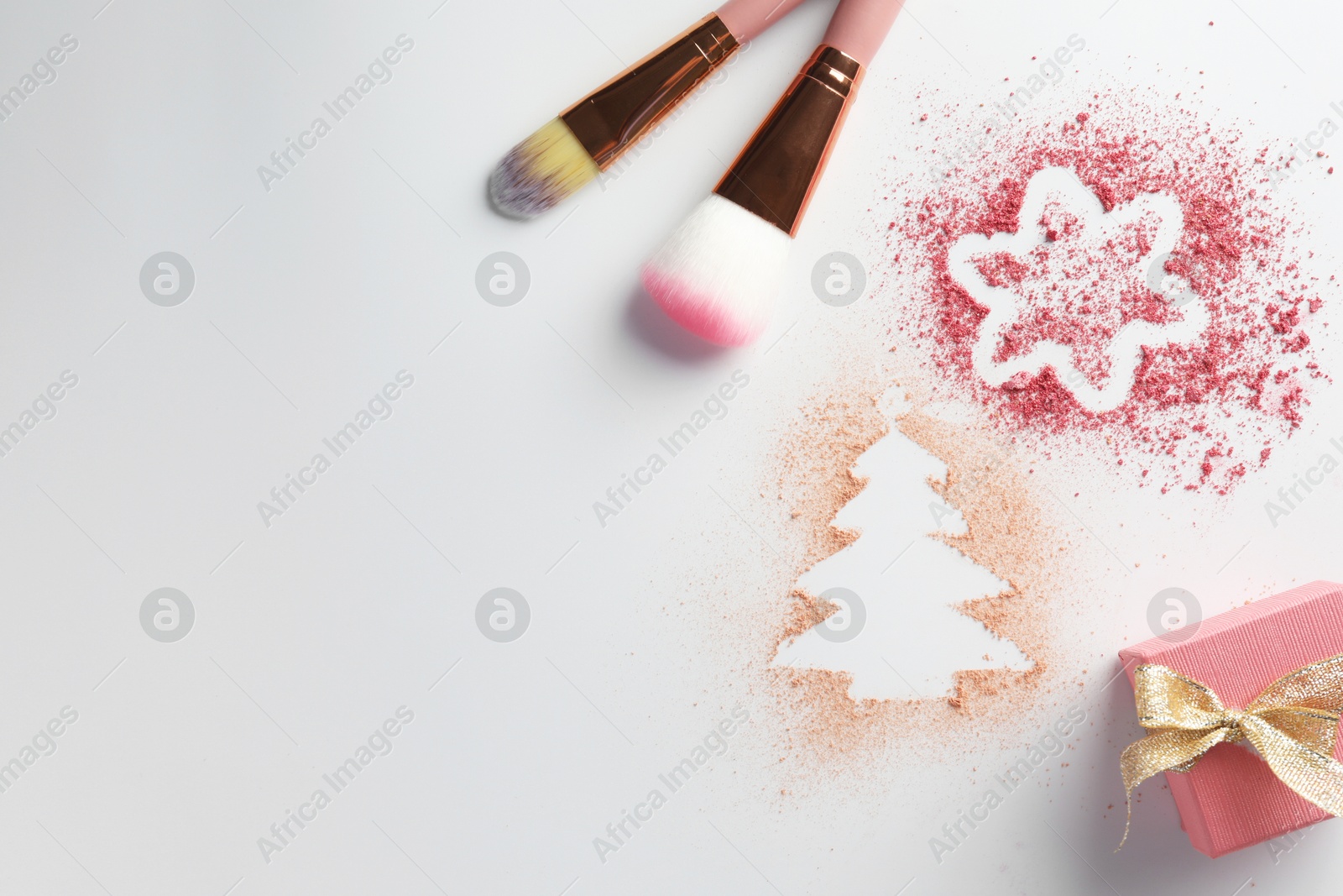 Photo of Christmas decorations made of powder and blush, gift box and makeup brushes on white background, flat lay. Space for text