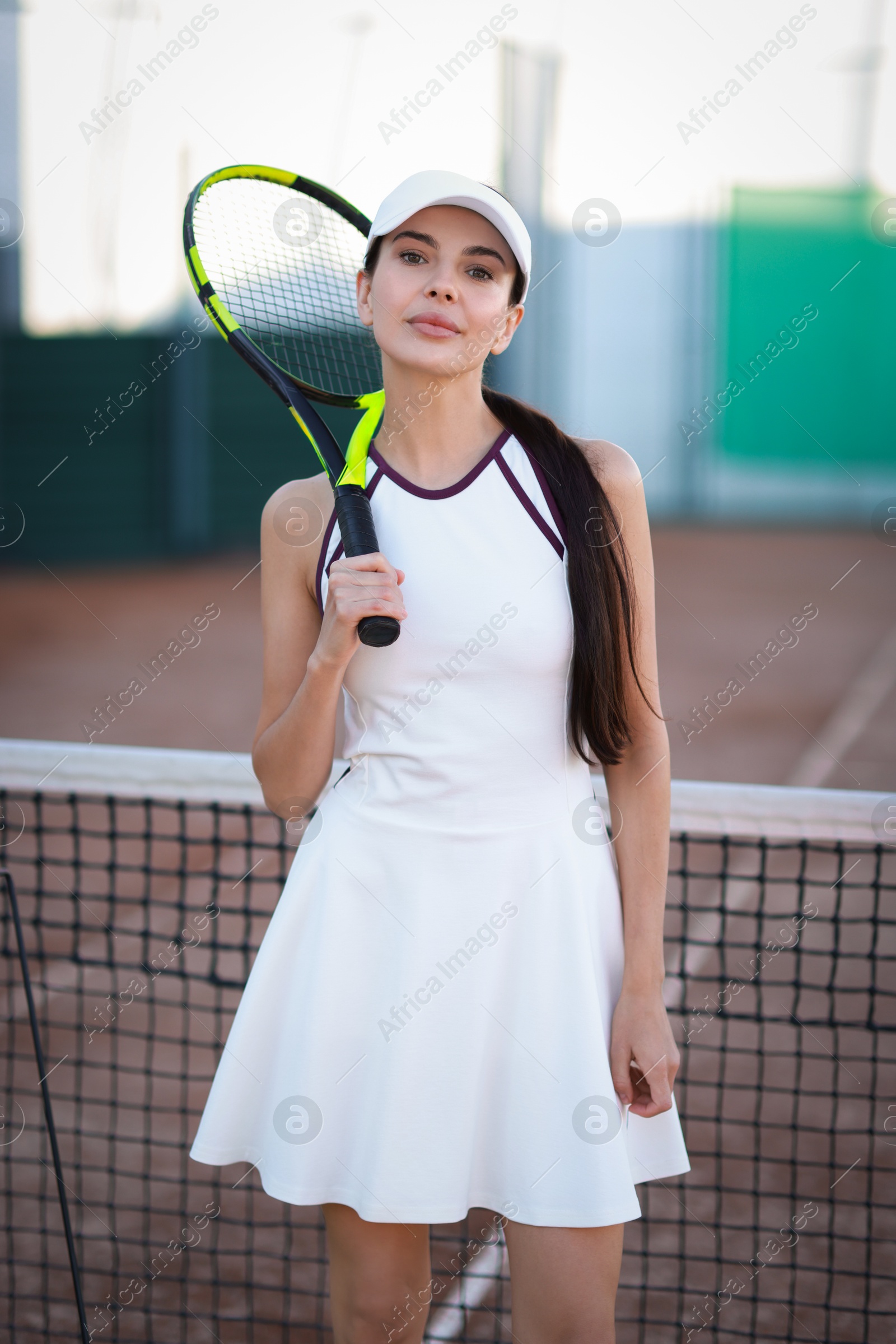 Photo of Beautiful woman with tennis racket on court