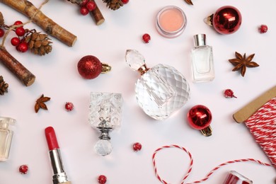 Christmas composition with perfume bottles on white background, flat lay