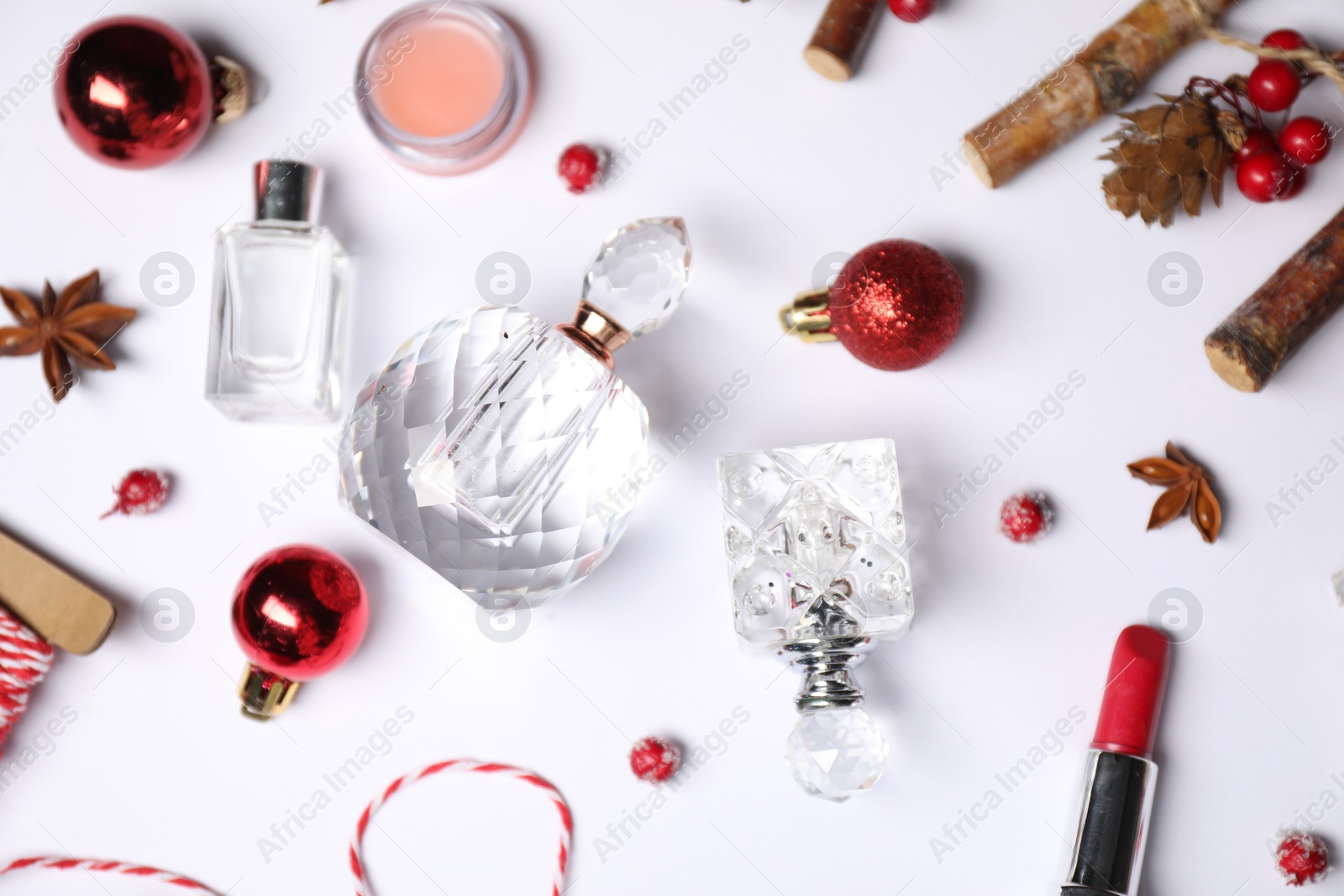 Photo of Christmas composition with perfume bottles on white background, flat lay