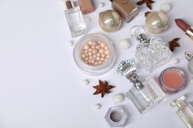 Photo of Christmas composition with perfume bottles and cosmetic products on white background, closeup. Space for text