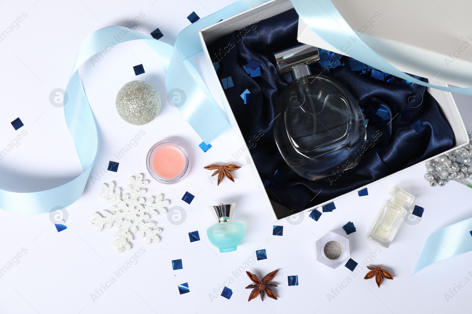 Photo of Christmas composition with perfume bottle on white background, flat lay