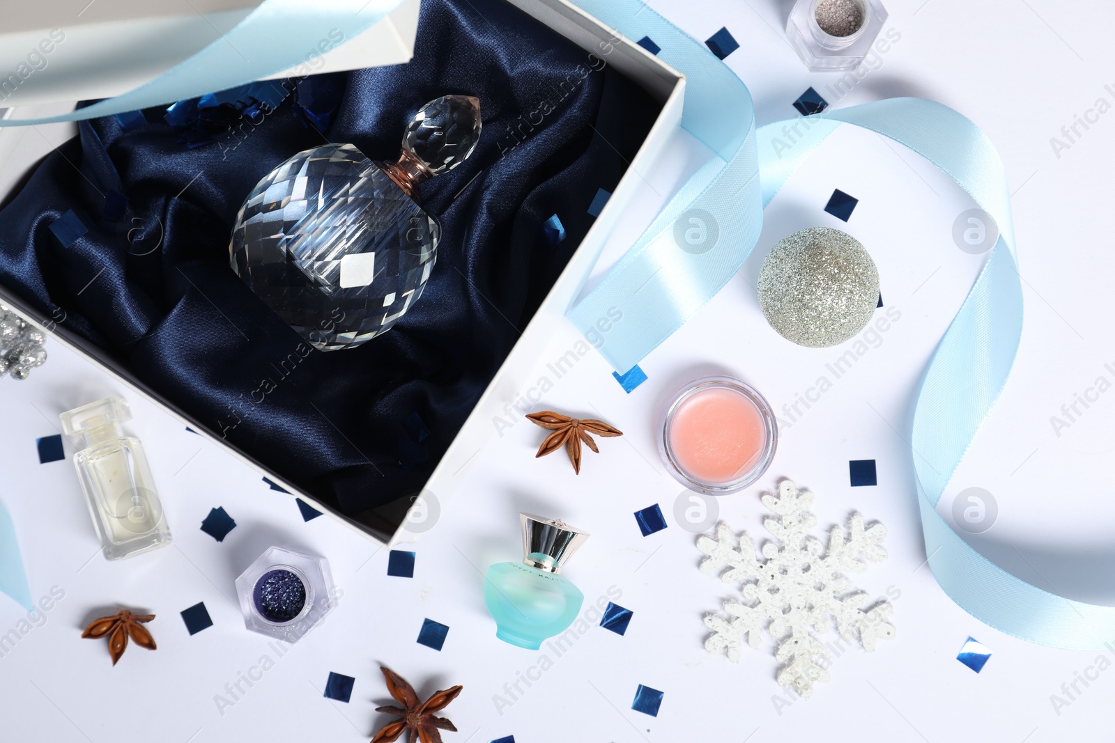 Photo of Christmas composition with perfume bottle on white background, flat lay