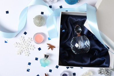 Photo of Christmas composition with perfume bottle on white background, flat lay