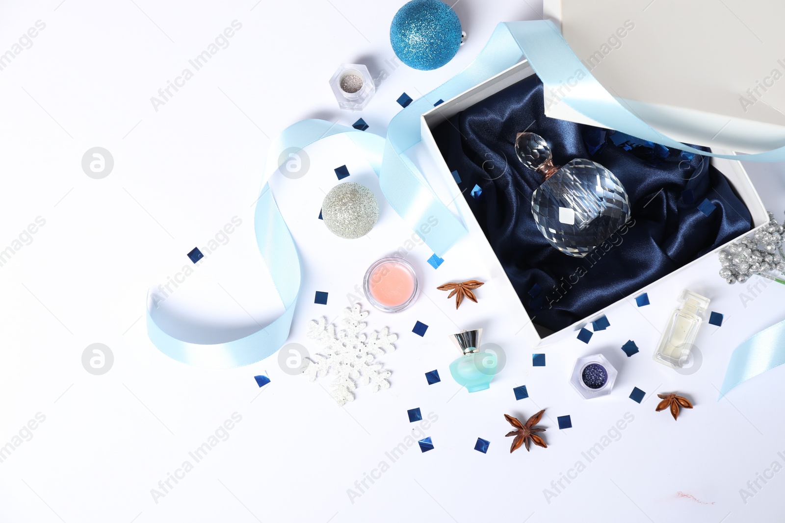 Photo of Christmas composition with perfume bottle on white background, flat lay