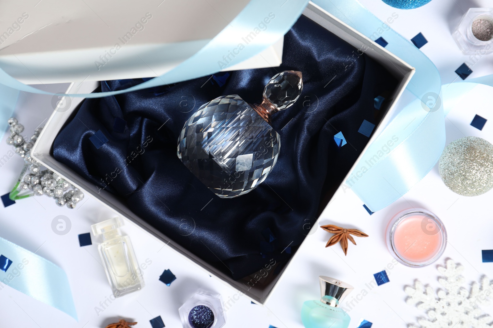 Photo of Christmas composition with perfume bottle on white background, flat lay