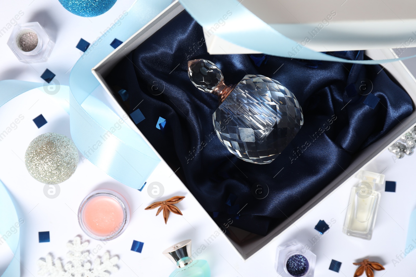 Photo of Christmas composition with perfume bottle on white background, flat lay