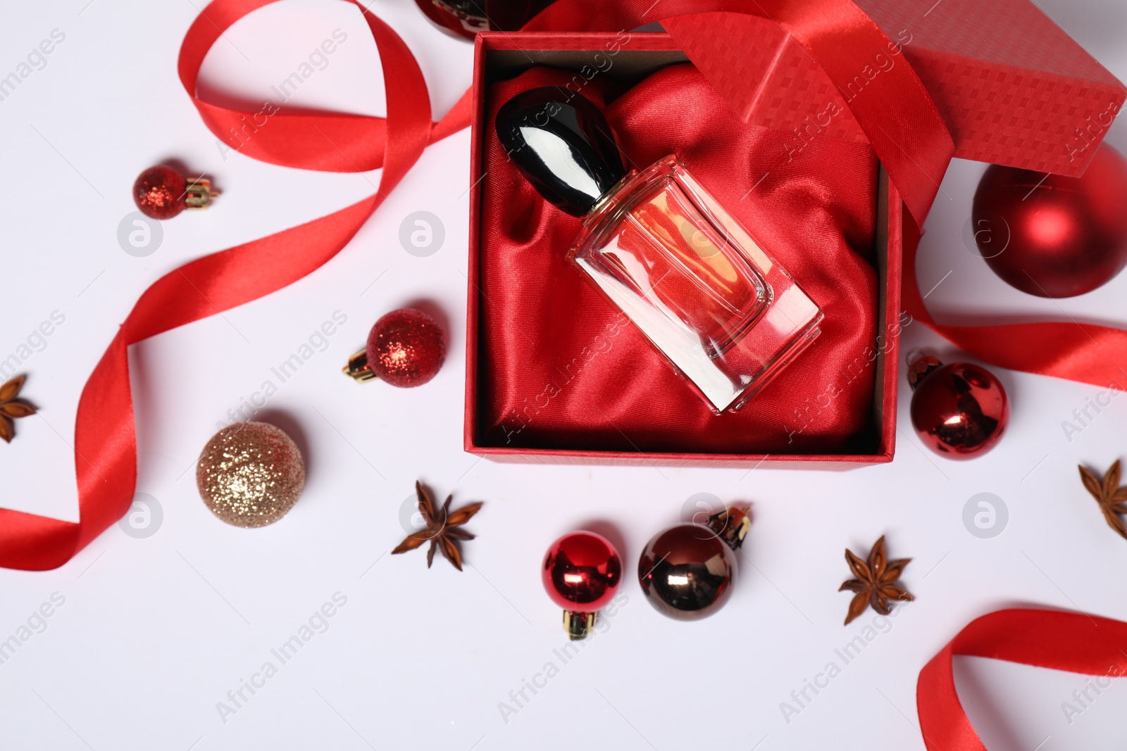 Photo of Christmas composition with perfume bottles on white background, flat lay