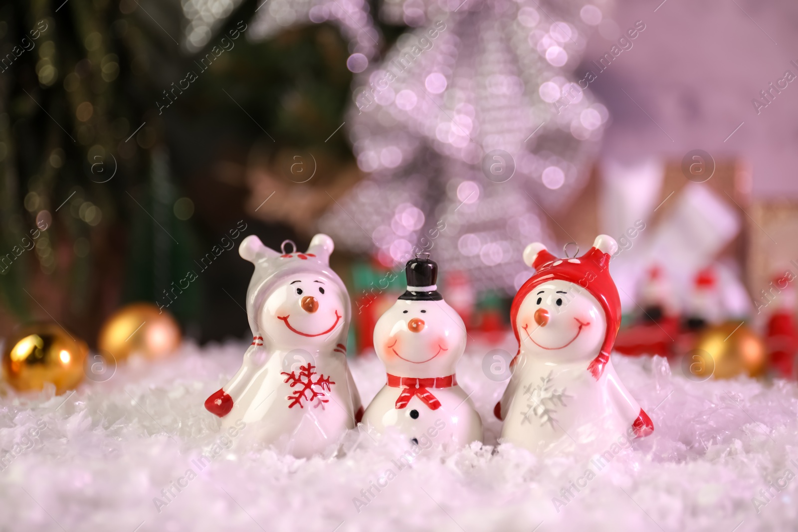 Photo of Different funny snowmen figures on artificial snow