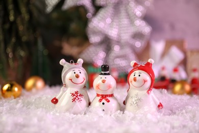 Photo of Different funny snowmen figures on artificial snow