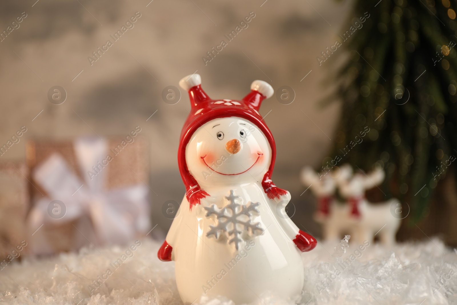 Photo of Funny snowman figure on artificial snow, closeup