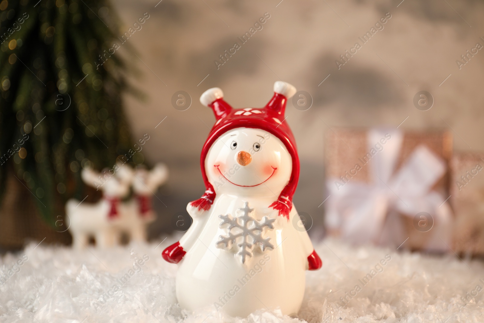 Photo of Funny snowman figure on artificial snow, closeup