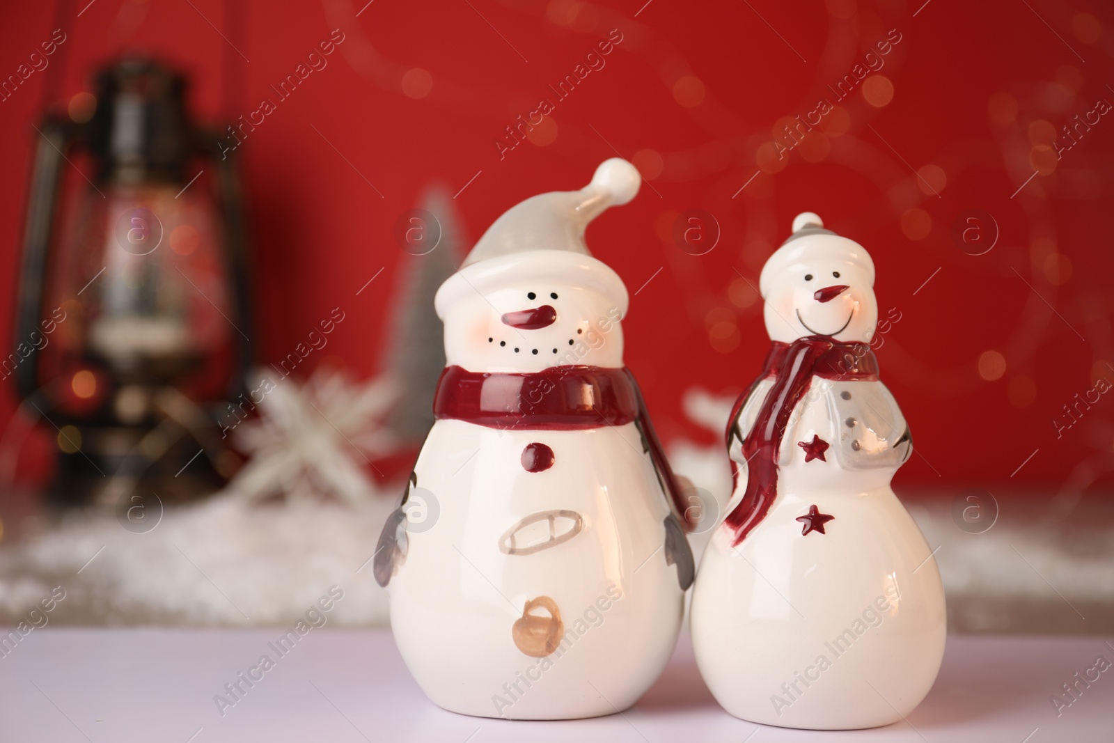 Photo of Funny snowmen figures on white table, closeup