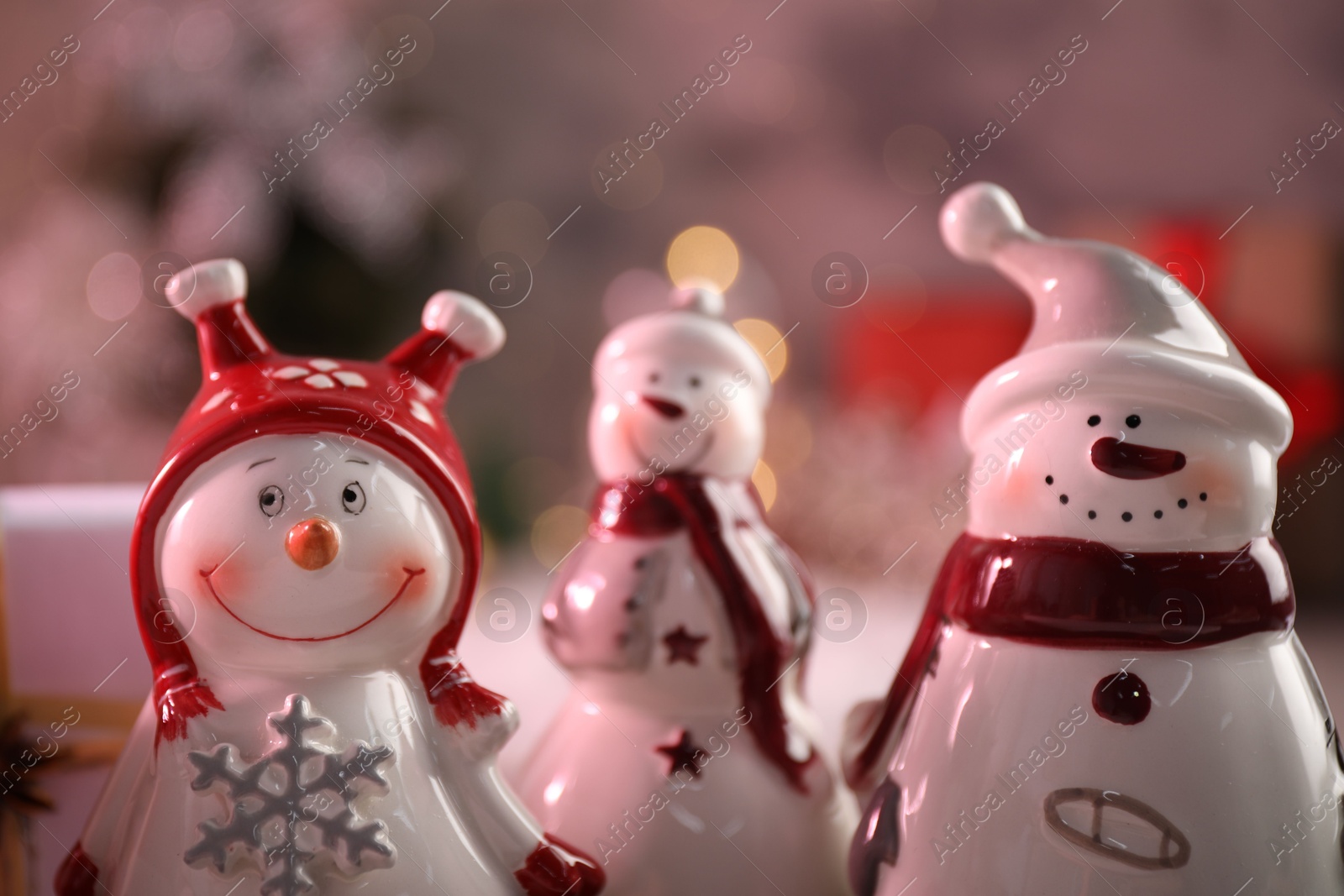 Photo of Funny snowmen figures in hats, closeup view