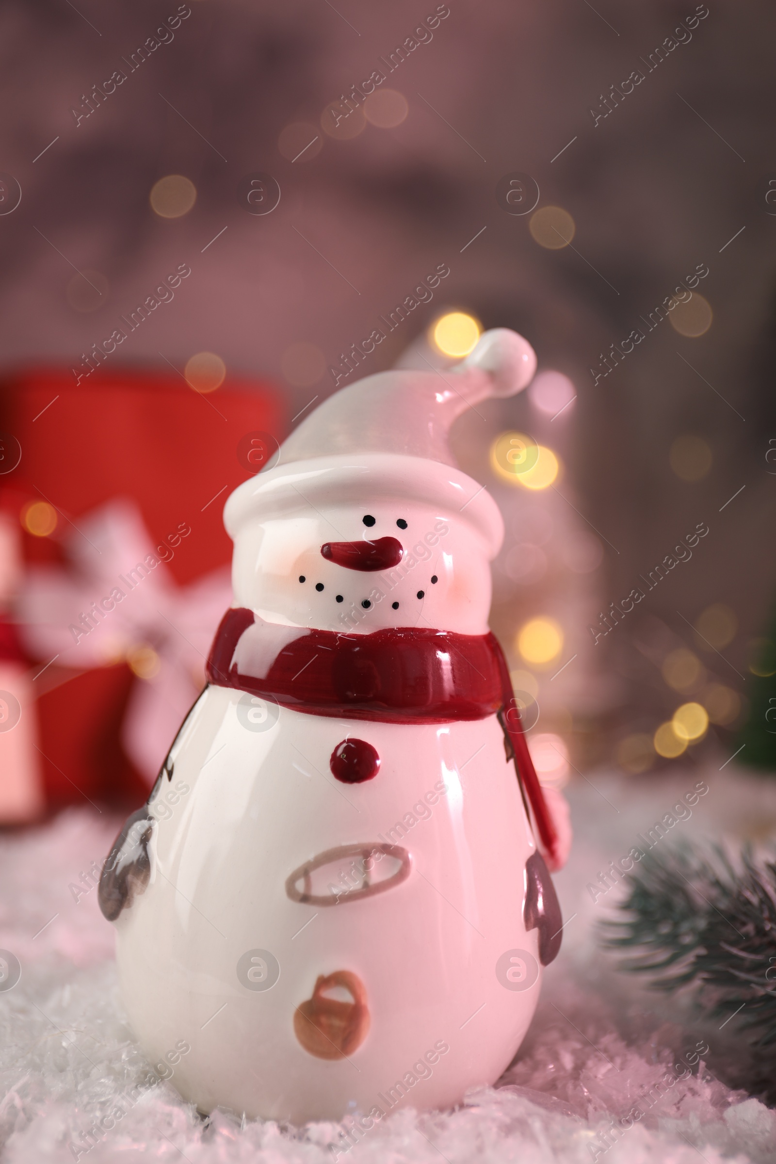 Photo of Funny snowman figure on artificial snow, closeup