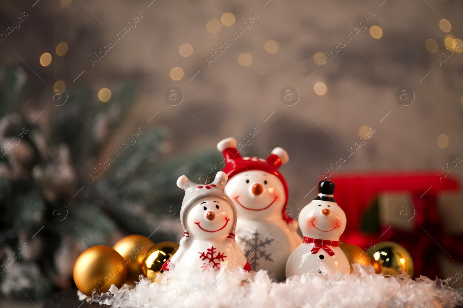 Photo of Funny snowmen figures and Christmas decor on table