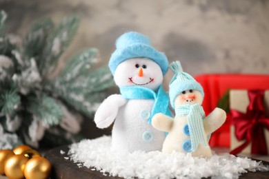 Photo of Funny snowmen figures and Christmas decor on table