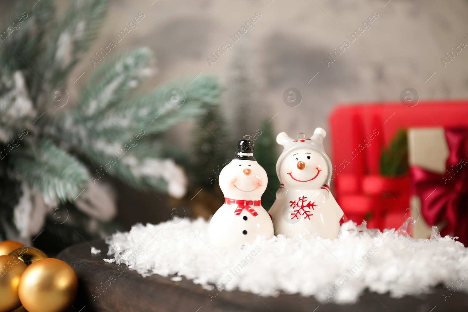 Photo of Funny snowmen figures and Christmas decor on table