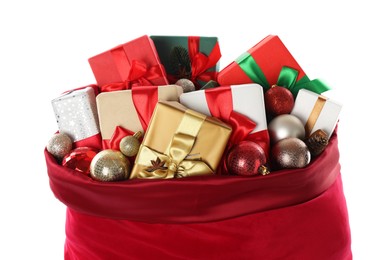 Photo of Santa Claus bag with gift boxes and Christmas balls isolated on white