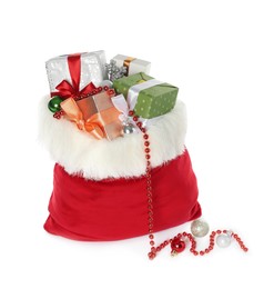 Photo of Santa Claus bag with gift boxes and Christmas balls isolated on white