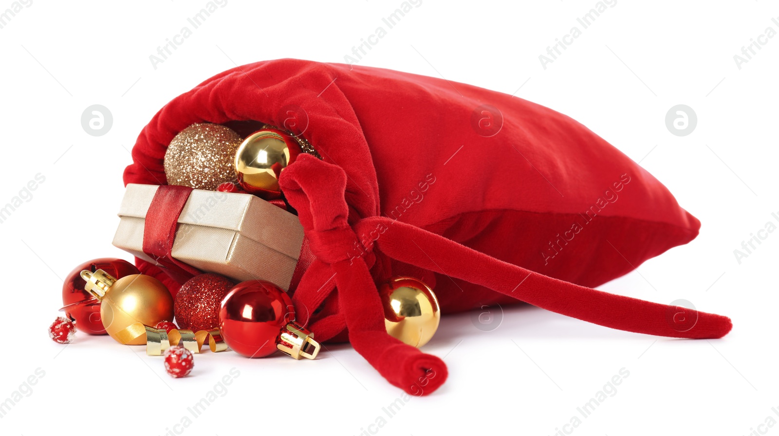 Photo of Santa Claus bag with gift boxes and Christmas balls isolated on white