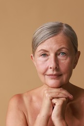 Photo of Face massage. Beautiful woman with healthy skin on beige background