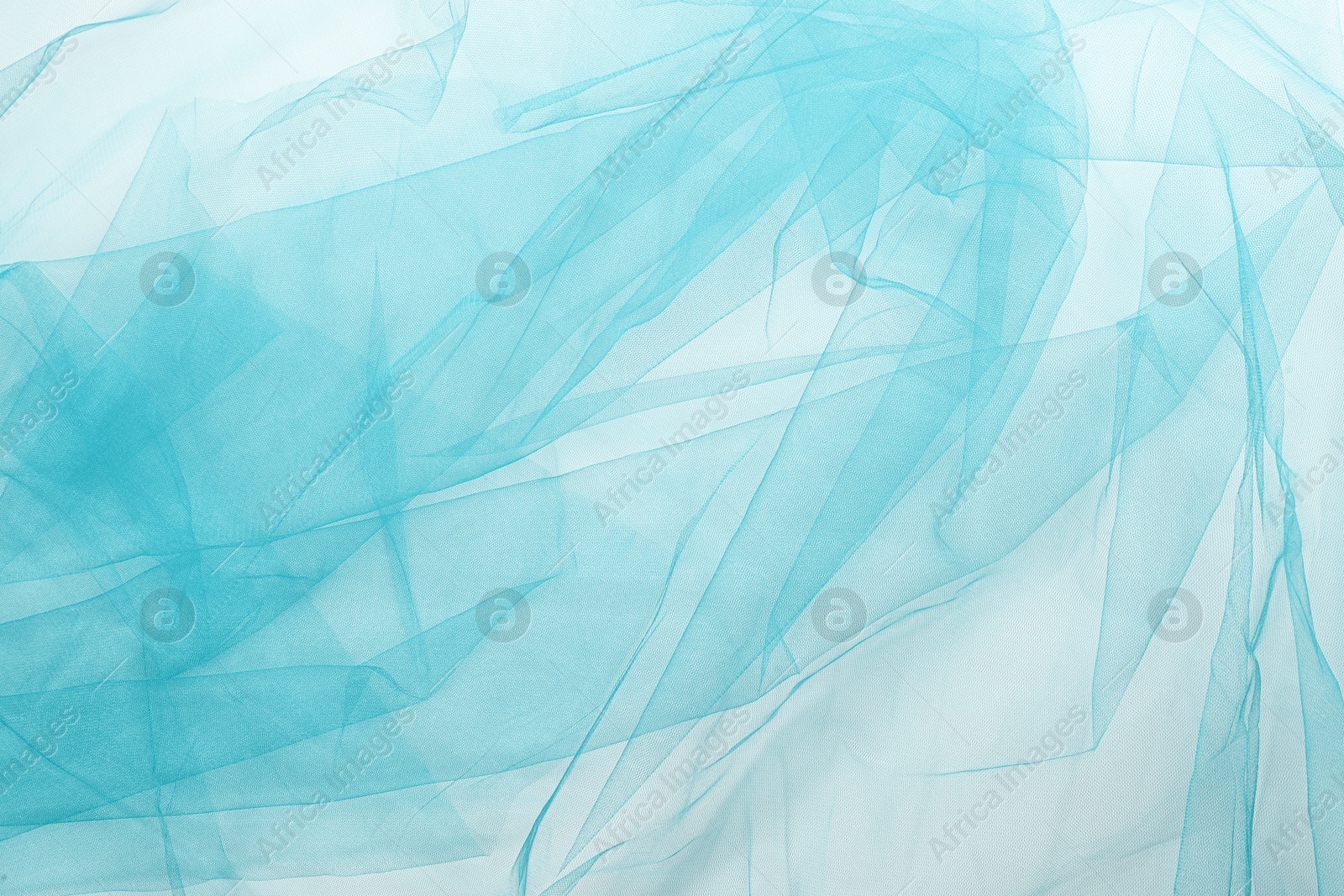 Image of Beautiful cyan color tulle fabric on white background