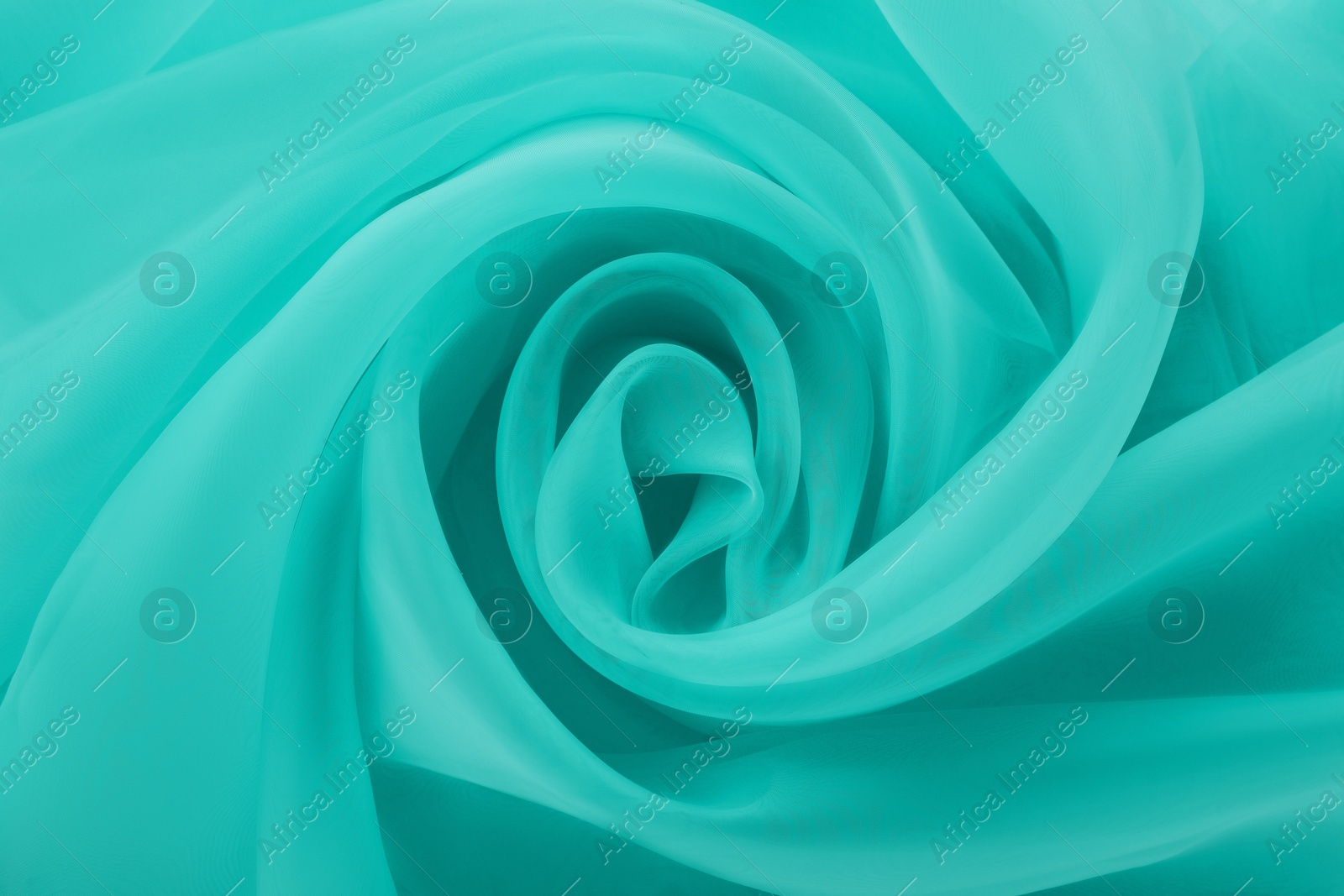 Image of Beautiful turquoise color tulle, closeup view of fabric