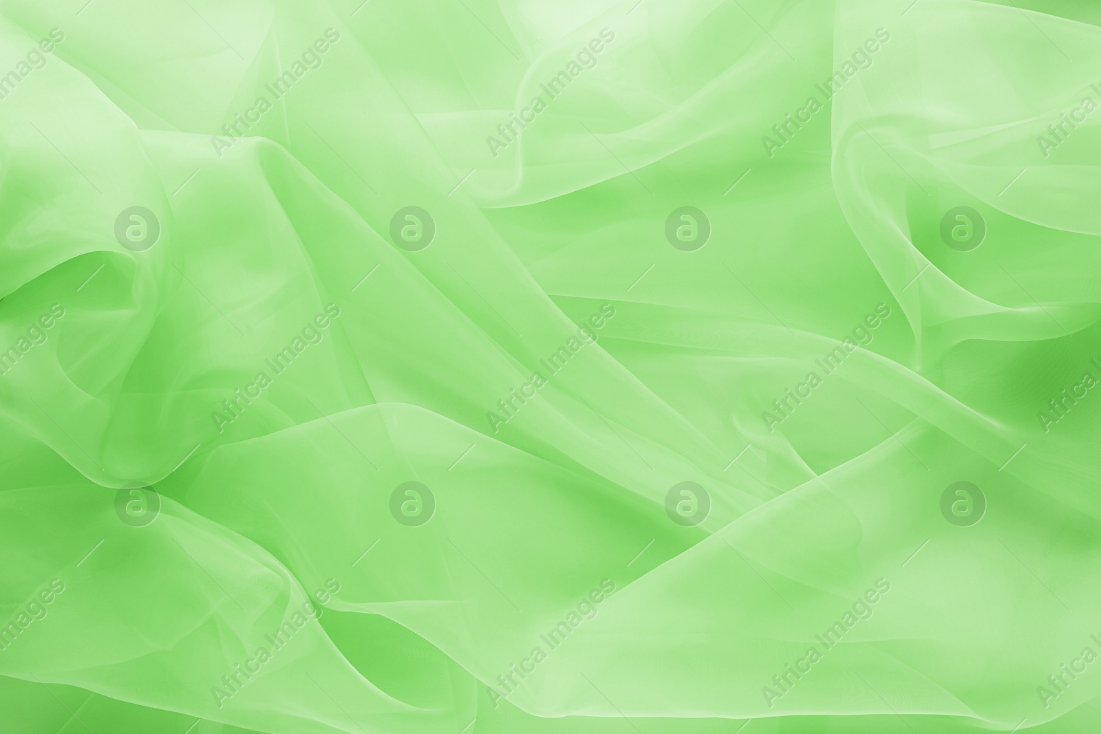 Image of Beautiful light green tulle, closeup view of fabric