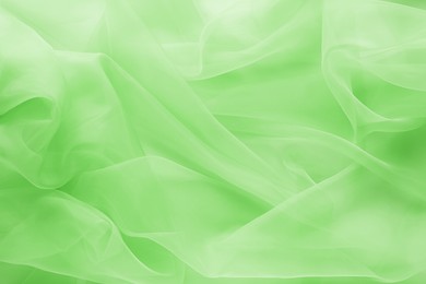 Image of Beautiful light green tulle, closeup view of fabric