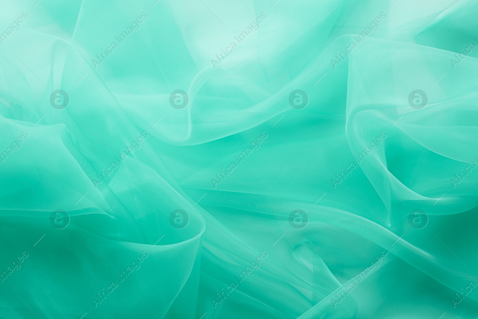 Image of Beautiful turquoise color tulle, closeup view of fabric