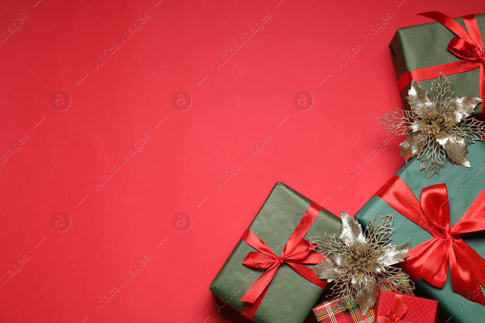 Photo of Flat lay Christmas composition with festive decor on red table, space for text