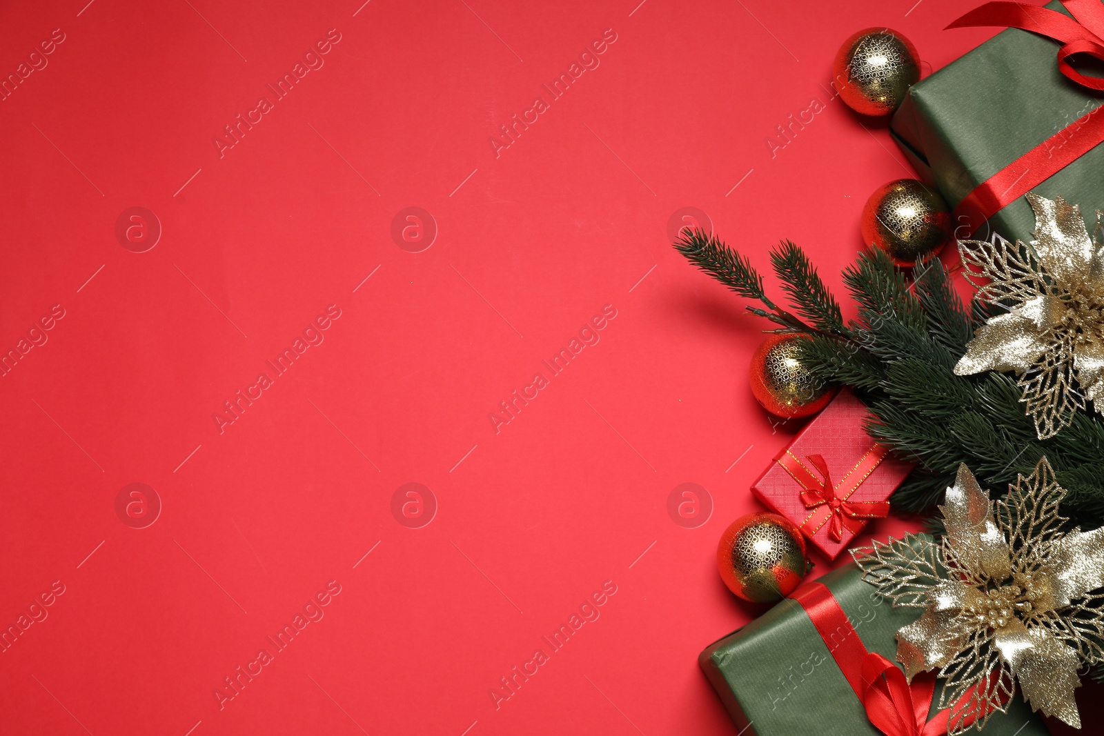 Photo of Flat lay Christmas composition with festive decor on red table, space for text