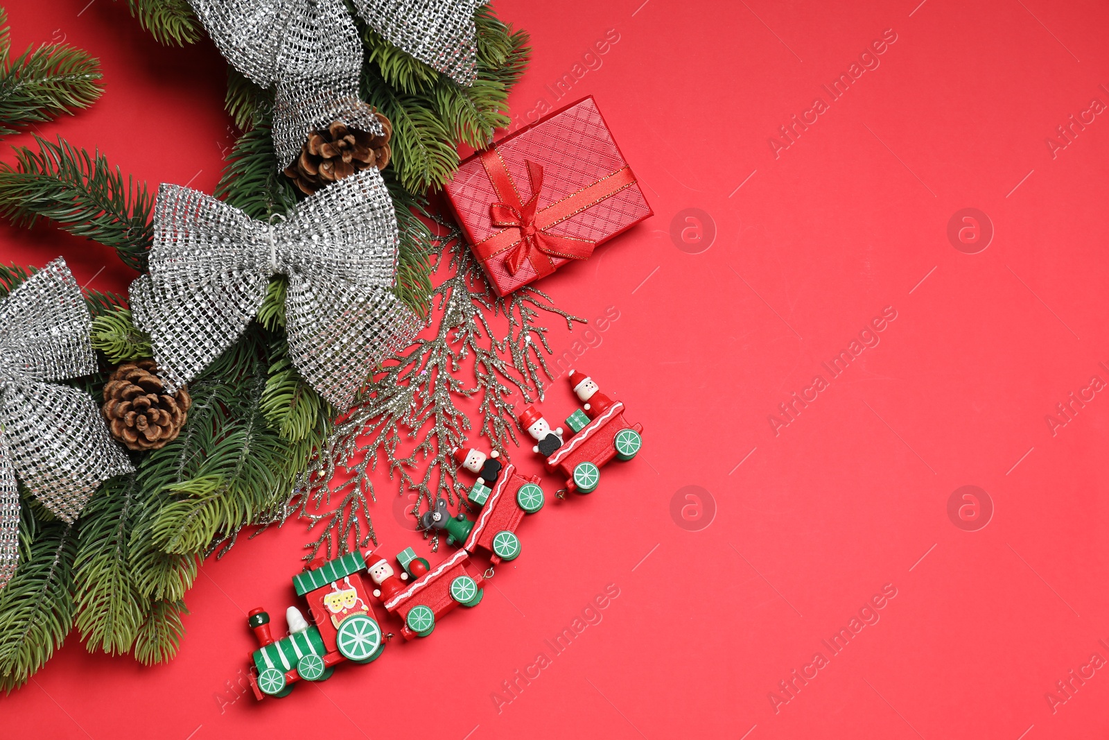 Photo of Flat lay Christmas composition with festive decor on red table, space for text