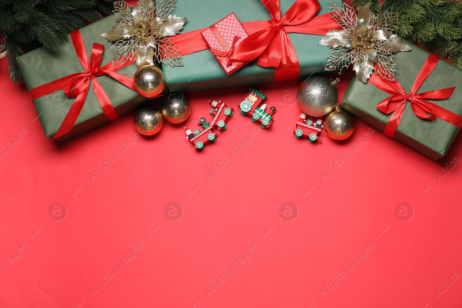 Photo of Flat lay Christmas composition with festive decor on red table, space for text