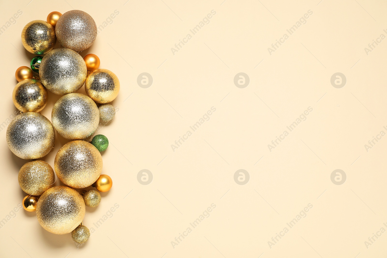 Photo of Different baubles on beige background, top view. Space for text