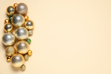 Photo of Different baubles on beige background, top view. Space for text