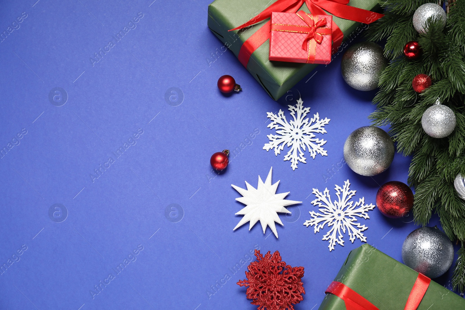 Photo of Different Christmas decor on blue background, flat lay. Space for text