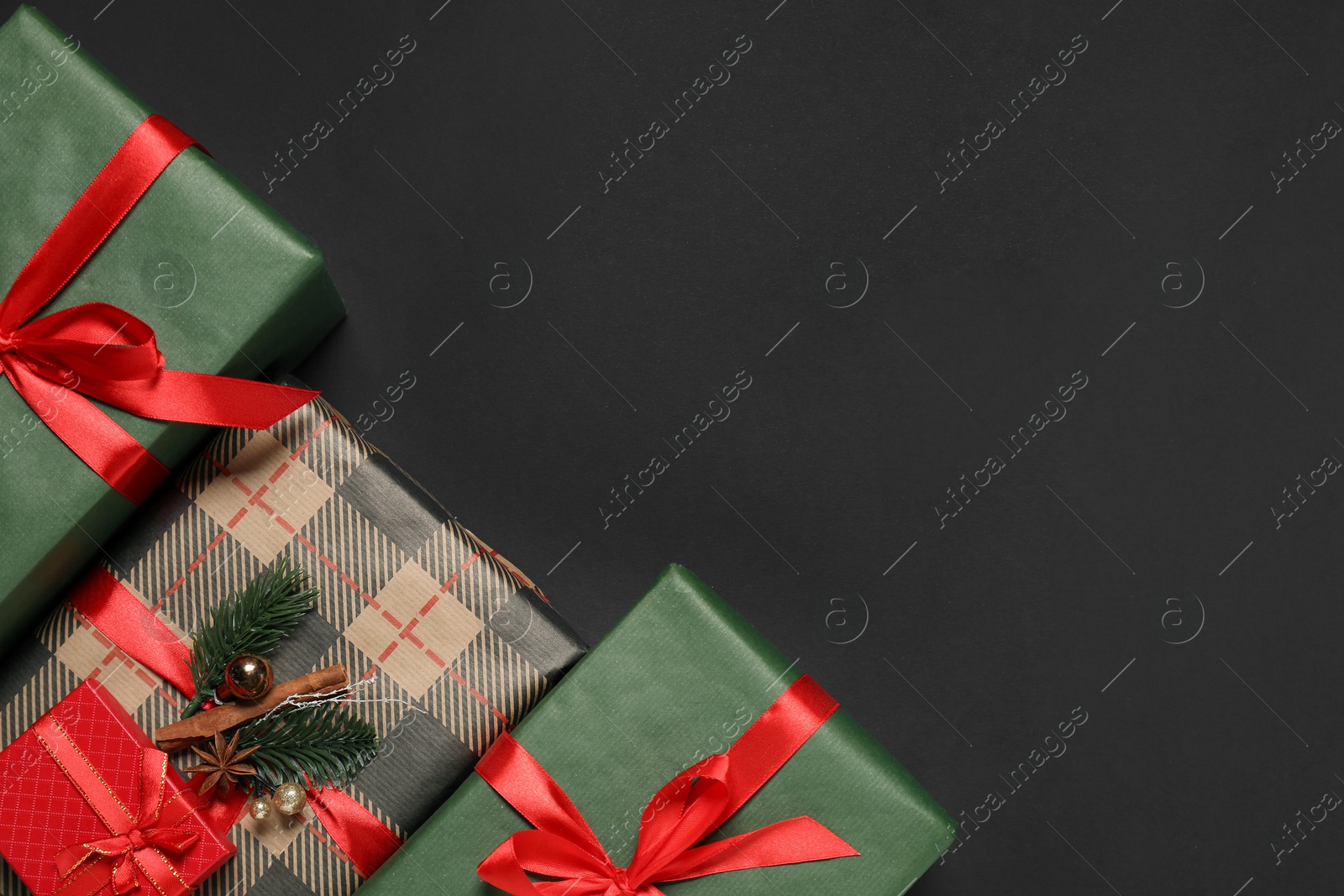 Photo of Different gift boxes on black background, flat lay. Space for text