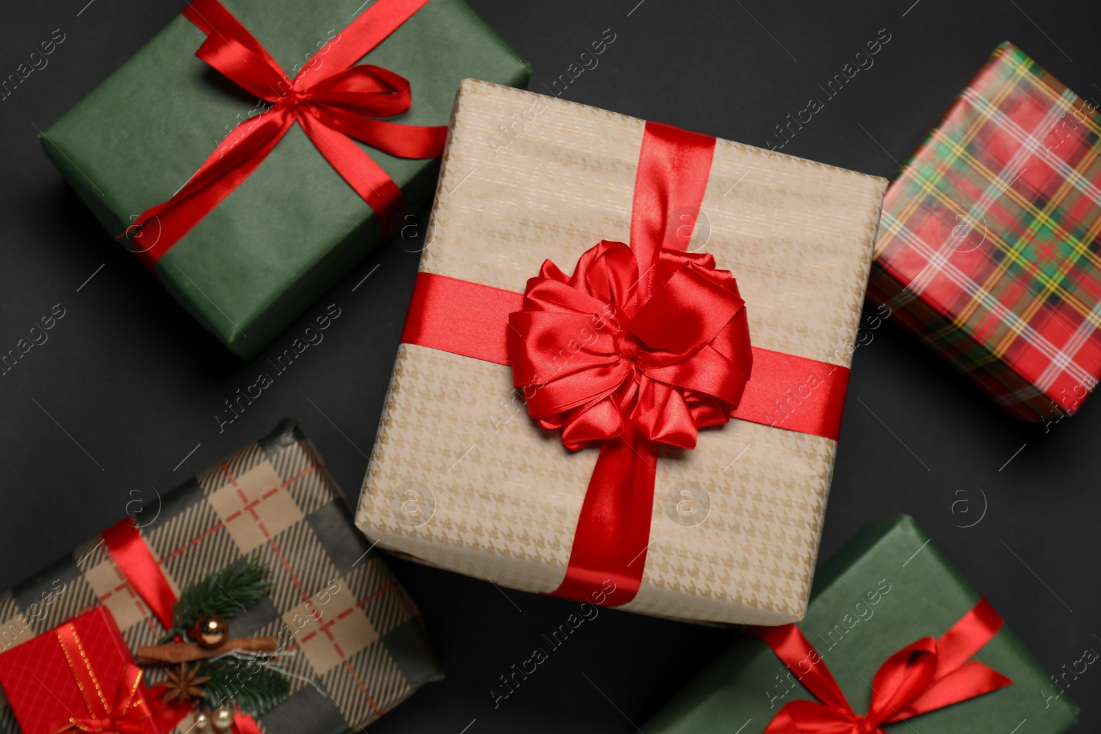 Photo of Different gift boxes on black background, flat lay