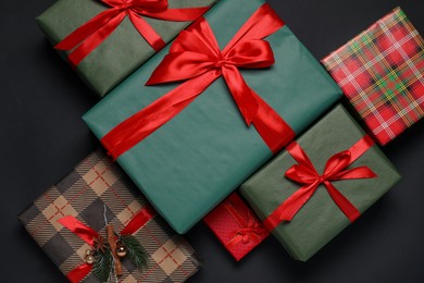 Photo of Different gift boxes on black background, flat lay