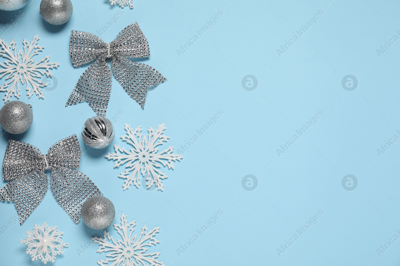 Photo of Different Christmas decor on light blue background, flat lay. Space for text