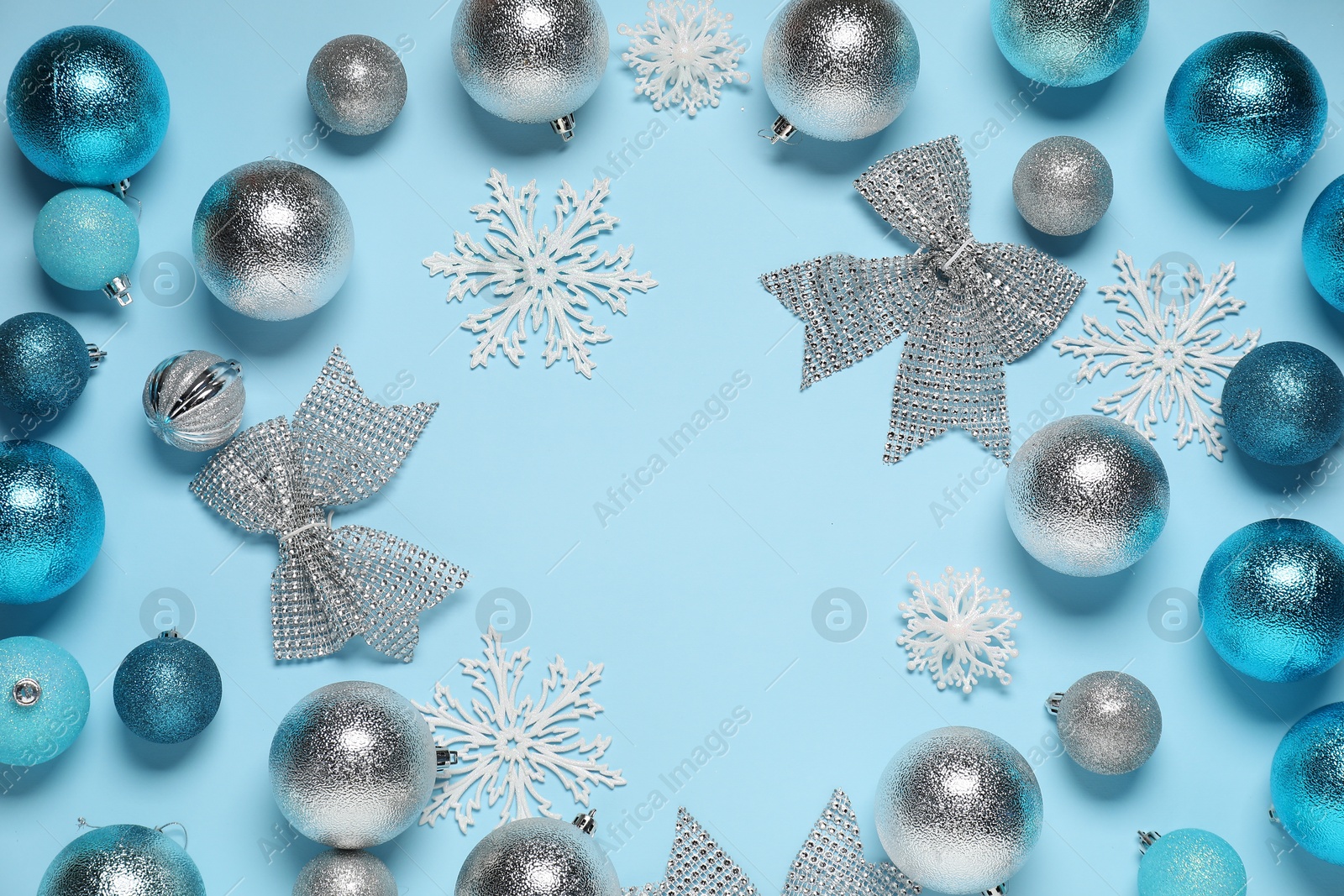 Photo of Frame of different Christmas decor on light blue background, flat lay. Space for text