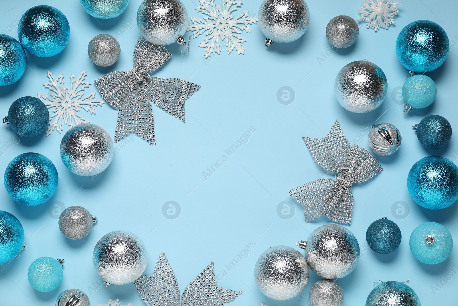 Photo of Frame of different Christmas decor on light blue background, flat lay. Space for text